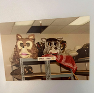 The head of a half-bodied animatronic next to an animatronic Harmony Howlette head.