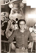 John next to a Chuck E. animatronic