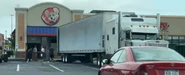 Crews removing things from the store after closure.