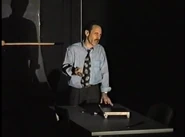 John performing for "Six Of The Best"