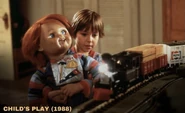 DL1.jpeg (206 KB) Andy showing Chucky the train set in his bedroom.