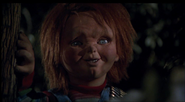 Chucky spying on Andy and Kristen in Child's Play 3.