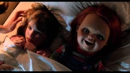 Alice in bed with Chucky in Curse of Chucky.