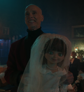 Wendell holding the prototype Wedding Belle doll in the Chucky episode Final Destination.