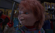 Chucky with his knife-hand in Child's Play 2.