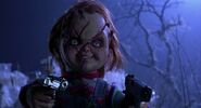 Chucky holding Jesse and Jade at gunpoint in Bride of Chucky.