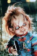 Chucky holding Jesse and Jade at gunpoint.