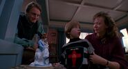 Joanne and Phil showing Andy the statue in Child's Play 2.