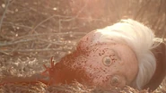 Sid's head laying on the ground, in Abruptio (2023)