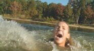 Christine Bently being jerked around the water by a shark in Shark Night