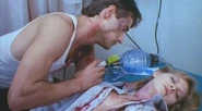 Barbara Crampton (right) with Bruce Abbott (left) in Re-Animator