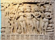 Ashoka, his empresses, and attendants in a relief at Sanchi Stupa (which appears to have inspired his in-game appearance)