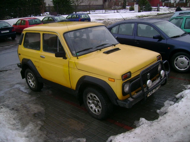 Yellow Lada Niva parked in snow