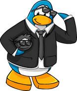 A Black Puffle wearing Black Sunglasses along with a secret agent in Issue #94 of the Club Penguin Times.