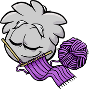 A Grey Puffle knitting in the Adopt A Puffle catalog.