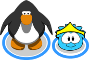 A puffle next to his owner wearing the Tiara