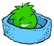 A Green Puffle sleeping in a Blue Puffle Bed