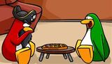 Rockhopper playing Mancala with a green penguin.