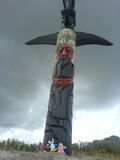 A Rescue Squad penguin, a Viking penguin, and Gamma Gal standing near a totem pole