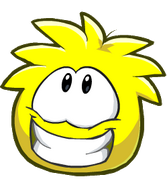 A yellow puffle grinning