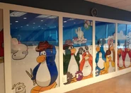 The Penguin Band, Herbert, and Klutzy, with other penguins and puffles on the wall of the Games Room