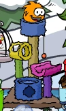 An Orange Puffle playing with one of the furniture items