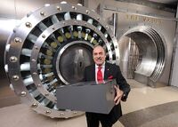 Muhtar Kent Coca-Cola company CEO places a metal box said to contain the Secret Recipe inside a five foot high safe.