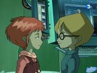 Jeremie and Aelita stand together by the supercomputer.