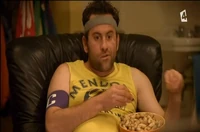 Jim eating snack while watch TV.