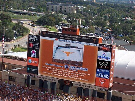 Colt McCoy pops the question beneath the Godzillatron