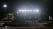 The GZ gate entrance at night, showing the heavy security