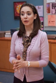 Annie wore this Pink cardigan to a study group meeting "prelimiwow" about their backpack door conundrum.Appearance: "Interpretive Dance"