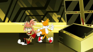 Tails just drags her back to the machine instead