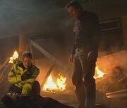 : John attacks  with a hammer, and covers up by dumping her on the tram crash site