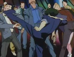 Spike roundhouse kicks some thugs.