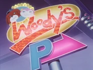 The electric sign outside of Woody's, with its two mascots on it.