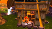 Crash in the village in the Worm Chase segment.