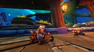 Dingodile and Crash slide past the Wumpa barrels in Nitro-Fueled