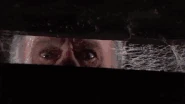 Something in the crate grabs Mike Latimer by the arm and starts biting him