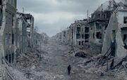 Man-walking-through-destroyed-city