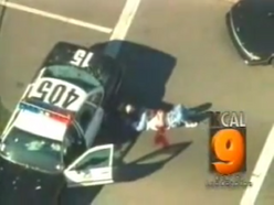 KCAL-TV live news footage of one of the victims bleeding out behind a police car.