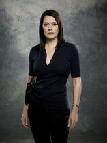 Promotional image of Prentiss with her holstered Glock 19.