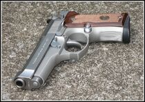 An Inox with brown grips.