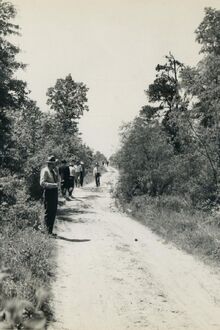 Law enforcement officers searching for evidence along Morris Lane