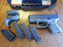A Glock 26 with three magazines.