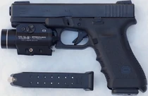 A Glock 17 with a light attachment.