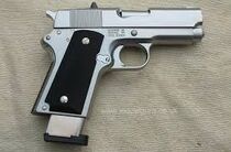 An M1911 pistol with an extended magazine.