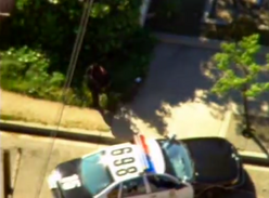Philips dodging gunfire behind a police car.