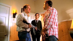 A member of the sect holding an AKM.