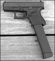 A Glock 26 with an extended magazine